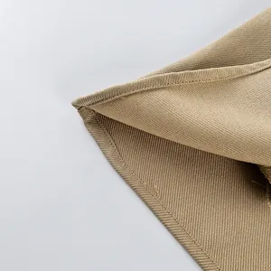 Close-up of khaki frosted velvet fabric and stitching detail on windbreaker