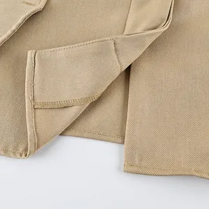 Detail shot of khaki matte velvet trench coat showing hem stitching and fabric texture
