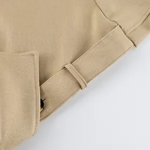 Close-up view of khaki brushed velvet trench coat fabric with belt loop and collar details