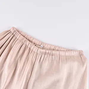 Close-up of shimmering casual pants with elastic waistband and silky fabric texture