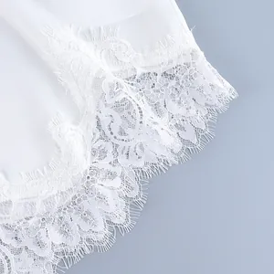 Detailed close-up showing delicate white eyelash lace trim on an elegant summer suit