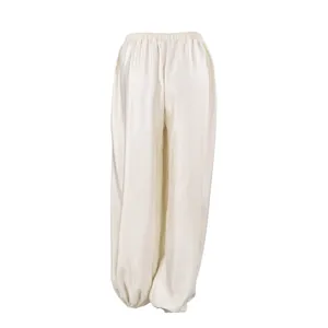 Close-up of elegant satin harem pants showing smooth fabric drape and elasticated ankles.