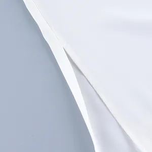 Detailed macro view showing the side slit and stitching on white fashion casual trousers