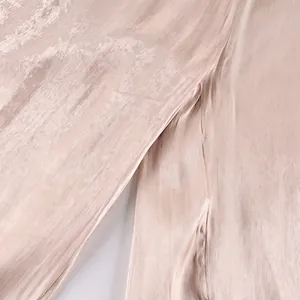Detailed macro shot of shimmering champagne satin fabric with fine vertical pleats texture