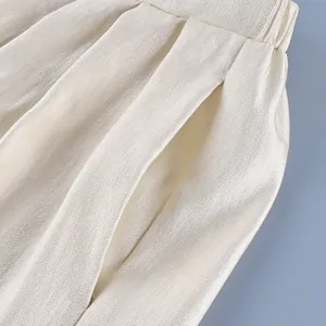 Close-up of premium satin lantern pants showing elegant pleats and side pocket detail.