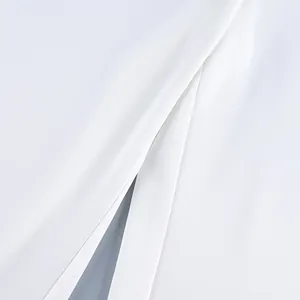 Macro view of high-quality white fabric texture and seam detail of a fashion suit
