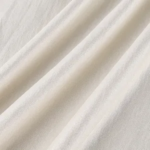 Close-up view of elegant pearl white satin fabric showing fine texture and smooth drapery.