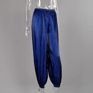 Detailed view of loose blue satin harem pants featuring elastic cuffs and high waist