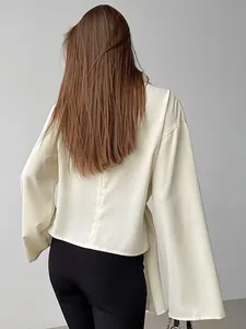 Back view of French style apricot chiffon blouse with slit sleeves and slim waist design