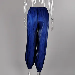 Detail view of the back of shiny blue satin relaxed-fit lantern pants with elastic cuffs