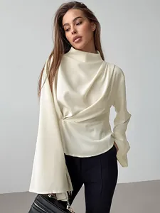 Elegant apricot chiffon blouse detail with waist-cinching pleats and split flared sleeves.