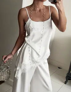 Elegant white satin camisole set with delicate lace trim and matching wide-leg trousers