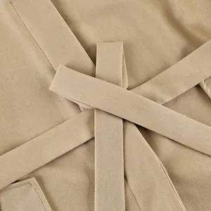 Close-up of beige khaki trench coat belt detail with premium fine twill fabric texture