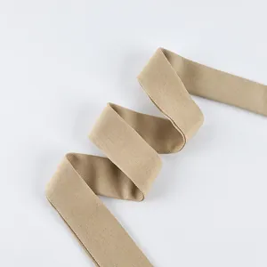 Detailed macro view of a tan frosted velvet waist belt for a classic trench coat