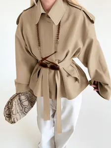 Khaki suede lapel trench jacket with waist tie and minimalist styling detail view