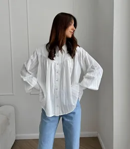 Elegant white pure cotton French shirt with puff sleeves paired with light blue jeans