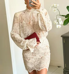 Detail view of intricate paisley lace long sleeve shirt and matching mini skirt set