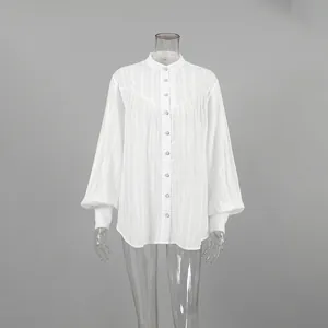 Detailed macro view of the white French puff sleeve cotton blouse with vertical stripes