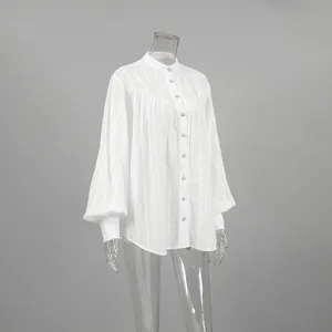Detailed view of white cotton French style puff sleeve blouse on a clear mannequin.