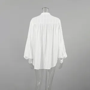Back view of a minimalist white cotton French blouse featuring elegant puff sleeves