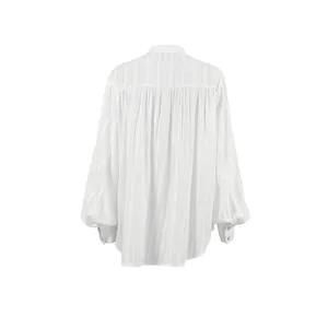 Detailed macro back view of white cotton French blouse with elegant puff sleeves