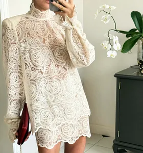 Detail view of off-white lace long sleeve blouse and matching A-line mini skirt set