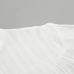 Close-up detail of white cotton French shirt fabric with delicate vertical lace patterns.