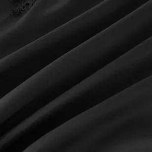 Gros plan sur la texture lisse du satin de soie synthétique noire avec dentelle