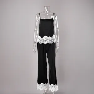 Detailed view of black two-piece pajama set with white lace camisole and pants