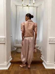 Elegant pale pink satin lantern pants for women in a stylish lifestyle interior setting