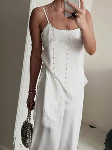 Elegant ivory white lace trim camisole and matching straight leg trousers two-piece set