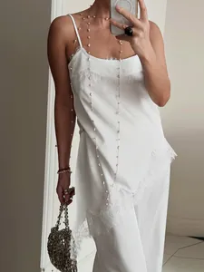 Elegant white satin two-piece set featuring a lace-trimmed camisole and straight-leg pants