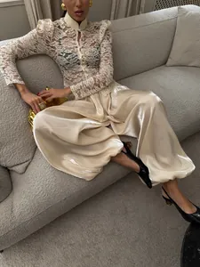 Elegant champagne satin lantern pants featuring a loose, flowing fit and silky finish