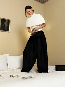 Elegant black satin lantern pants worn by an Asian model in a stylish bedroom setting
