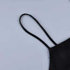 Macro detail view of slim black camisole strap and smooth fabric texture for summer set