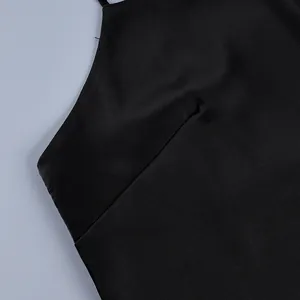 Close-up detail of black satin camisole top showing strap and seam stitching