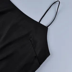 Detailed close-up showing the thin spaghetti strap and neckline of a black camisole top