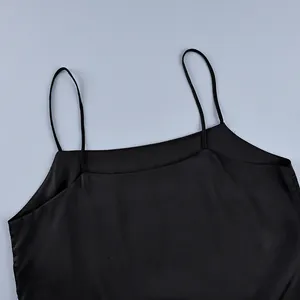 Close-up detail of a minimalist black spaghetti strap camisole with a square neckline