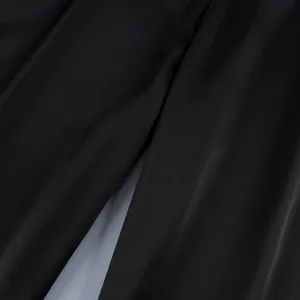 Close-up detail of the smooth texture and fine stitching on these black straight-leg pants