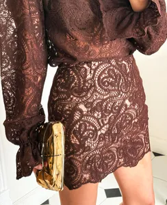 Close-up detail of intricate chocolate brown lace pattern on stylish two-piece set outfit