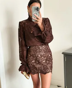 A detailed mirror selfie view showing the fit and lace texture of the brown two-piece set.