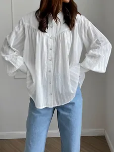 Elegant white cotton French blouse featuring long bubble sleeves and textured stripes