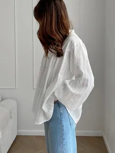 Elegant minimalist white cotton French blouse with puff sleeves for a chic spring look.