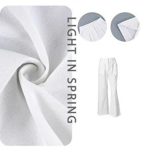 Close-up of white wide-leg trousers fabric texture and elegant high-waist design