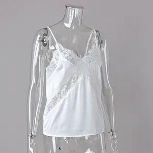 Detailed view of white lace patchwork camisole featuring delicate floral mesh trim