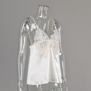 Side view detail of white satin camisole with delicate lace trim on transparent mannequin