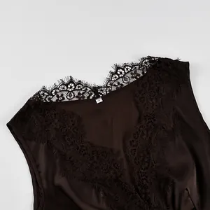 Close-up detail of dark brown satin top with black eyelash lace trim on V-neckline