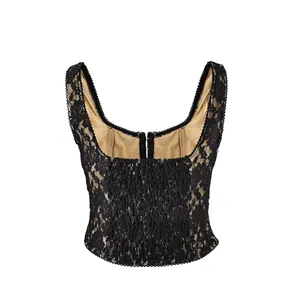 Close-up view of black lace camisole with smocked texture and beige lining.