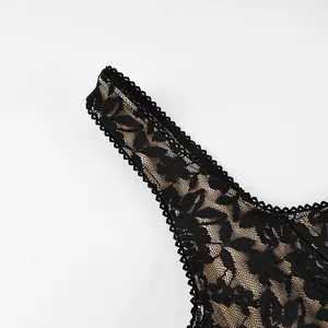 Detailed macro view showing the intricate floral lace of a black camisole shoulder strap.