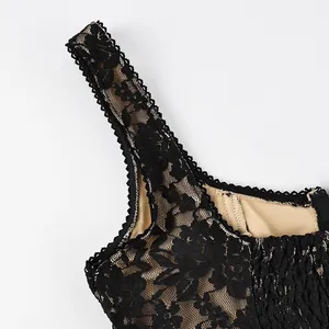 Close-up detail of delicate black floral lace strap and scalloped neckline on camisole